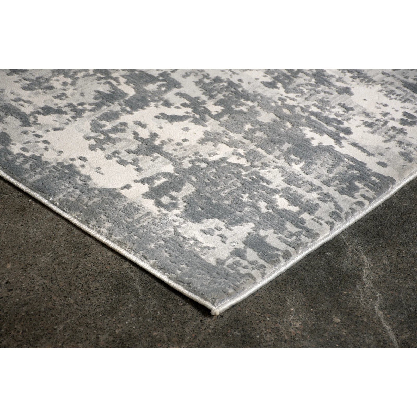 Gray patterned rug on a dark floor