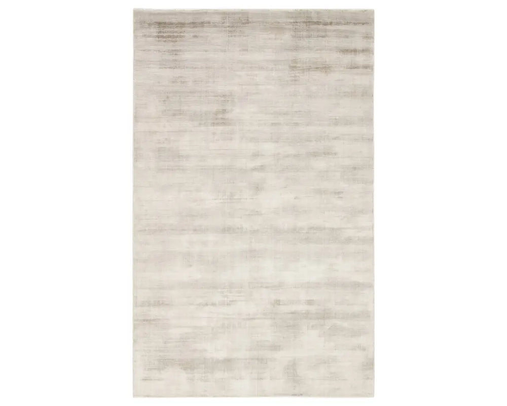 A light taupe area rug with a solid pattern, handwoven from 100% viscose.