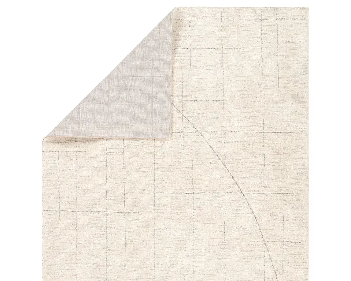 A beige area rug with a geometric pattern.