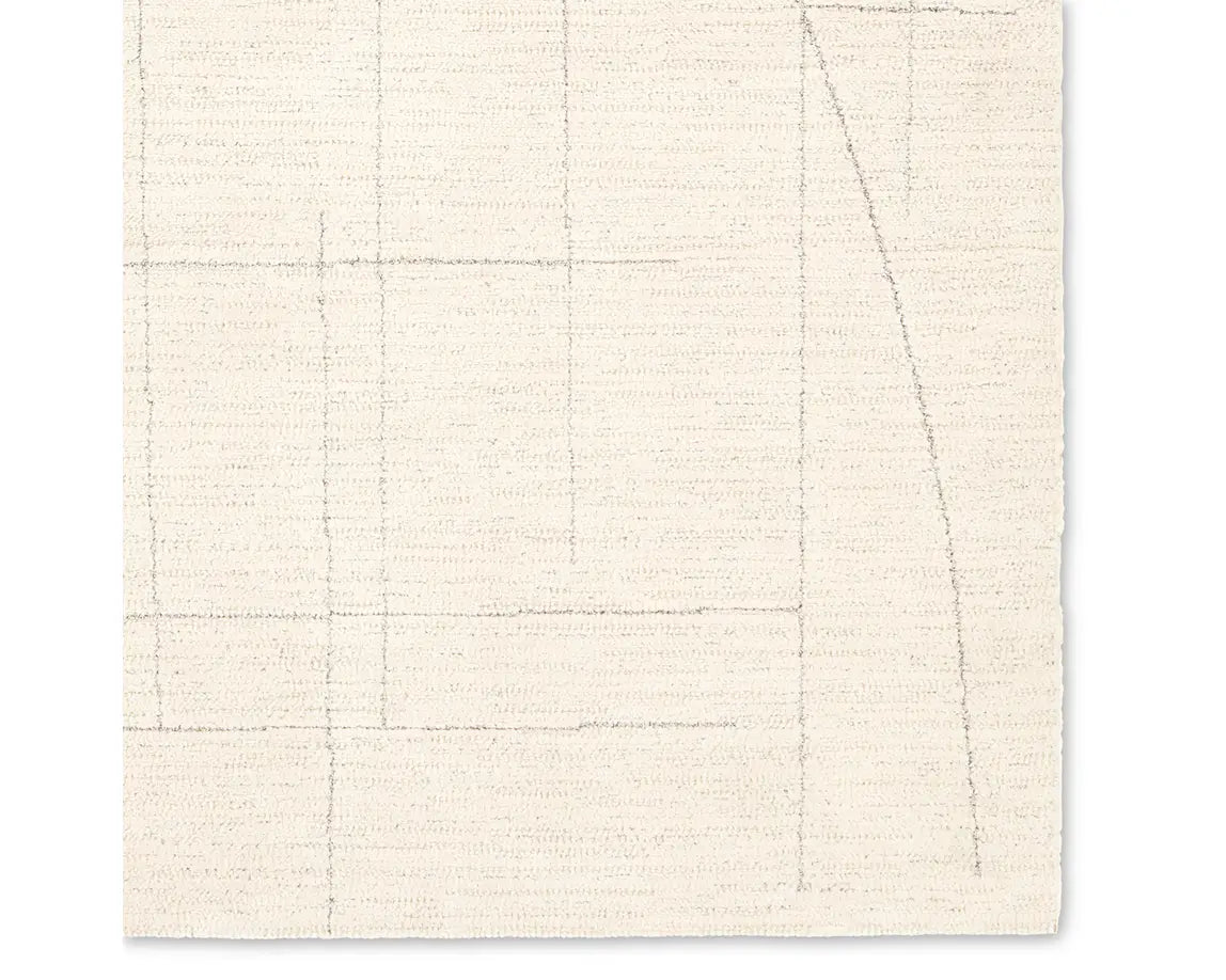 A beige area rug with a geometric pattern.