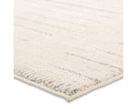 A rectangular beige area rug with a simple geometric pattern and power loomed construction.
