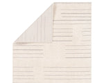 A rectangular beige area rug with a simple geometric pattern and power loomed construction.