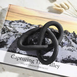 Black abstract sculpture on a book 