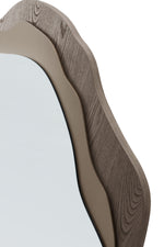 Decorative mirror with a wavy wooden frame on a white background