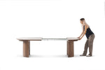 Person interacting with a large adjustable table on a white background