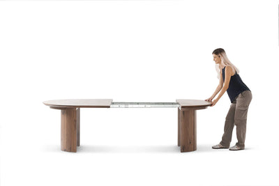 Person interacting with a large adjustable table on a white background