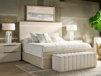 Modern bedroom with a bed, nightstands, and lamps.