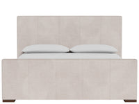 A light beige upholstered bed frame with a tall segmented headboard and matching footboard, shown with two white pillows and a white sheet against a plain white background.
