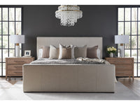 Modern bedroom with a beige upholstered bed, wooden nightstands, and a chandelier.