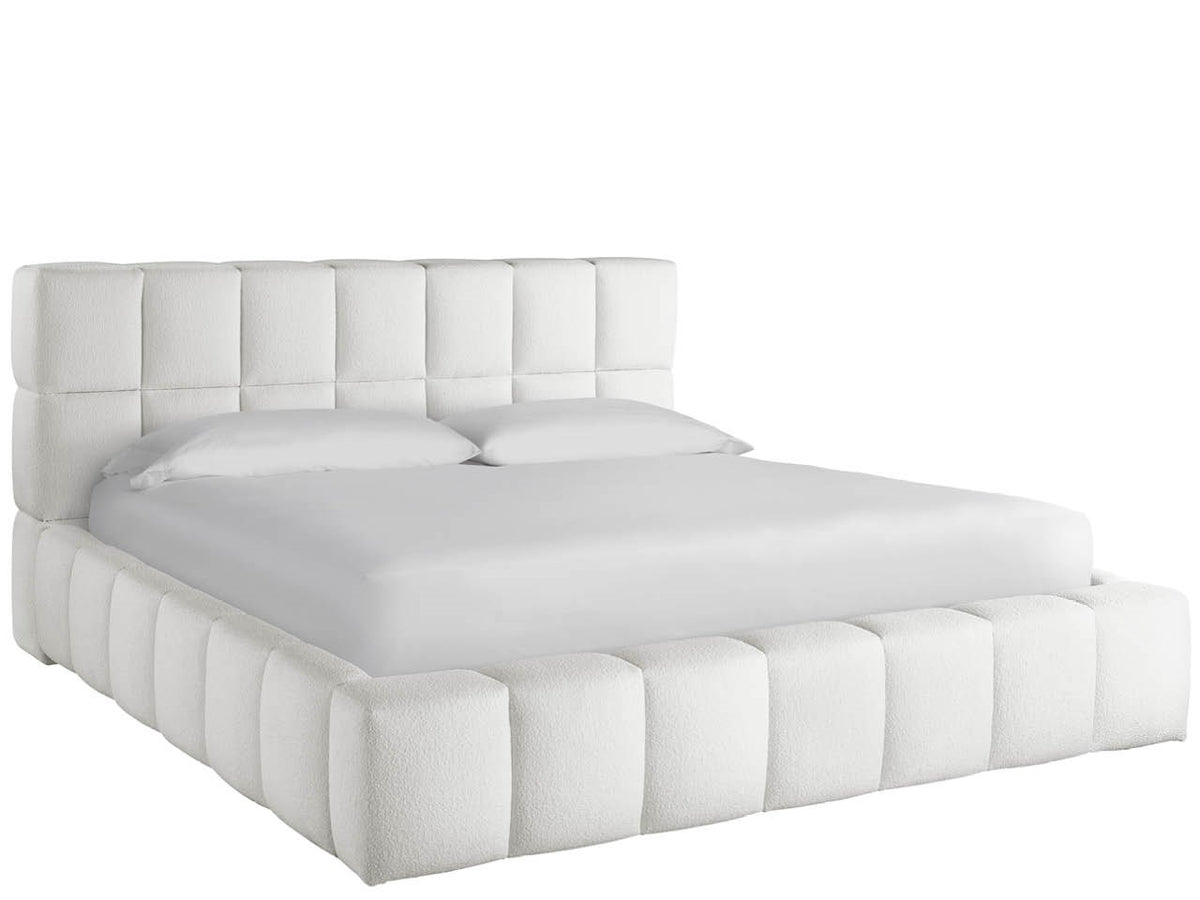 White tufted bed with matching headboard on a white background
