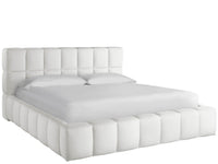 White tufted bed with matching headboard on a white background