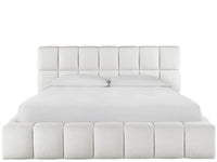 White upholstered bed with tufted design on a white background