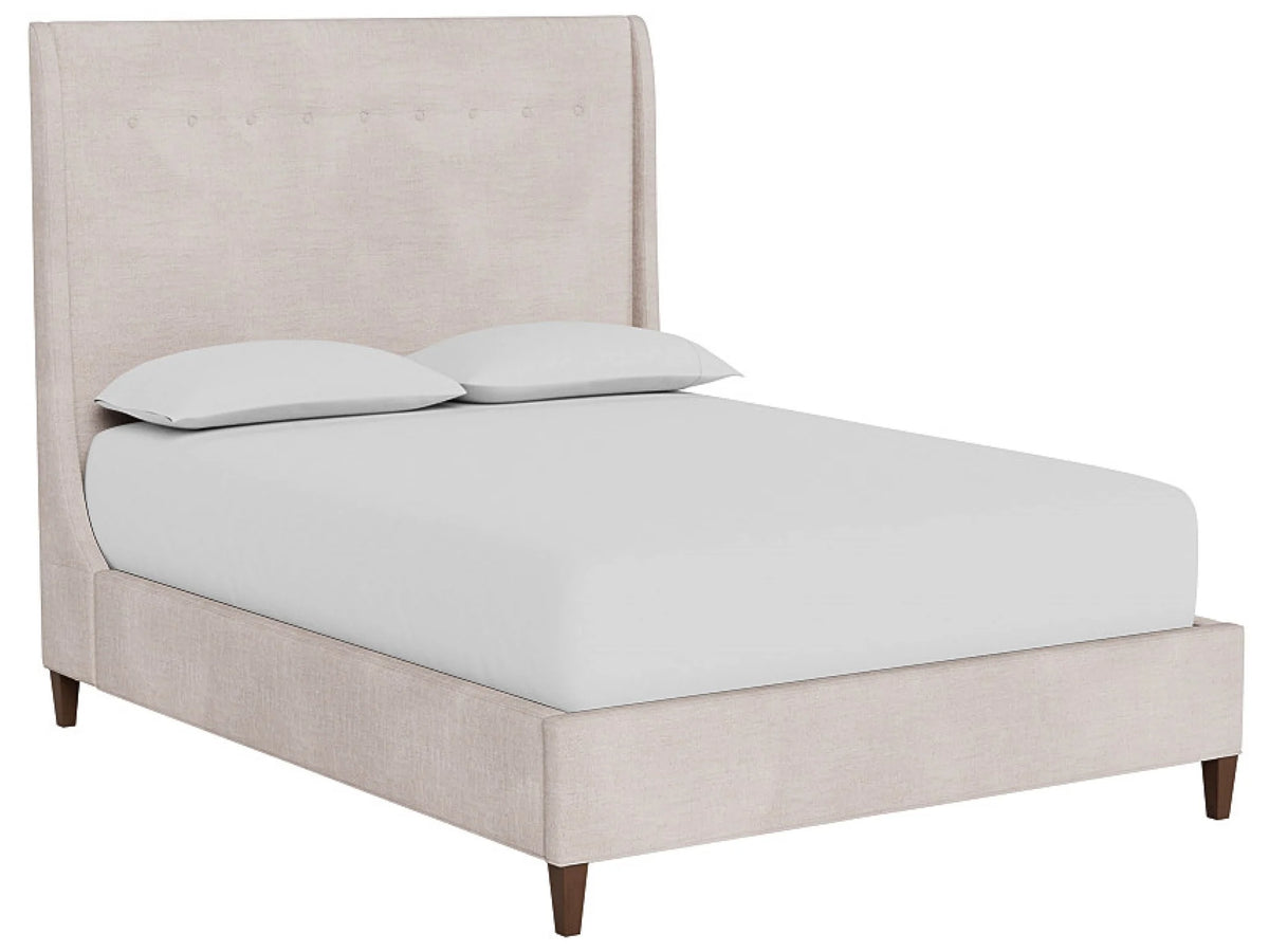 Beige upholstered bed with white bedding on a white background