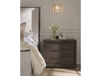 Bedroom scene with a nightstand, bed, and wall sconce.