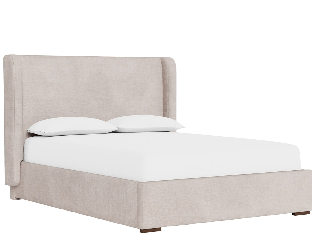 An upholstered bed frame in a light beige fabric, shown with a white mattress and two white pillows against a solid white background.