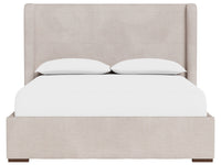 An upholstered bed frame in a light beige fabric, shown with a white mattress and two white pillows against a plain white background.