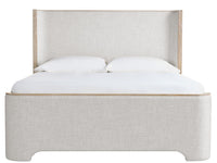 Gray upholstered bed with white bedding on a white background