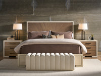 Modern bedroom setup with a bed, nightstands, and lamps against a textured wall.