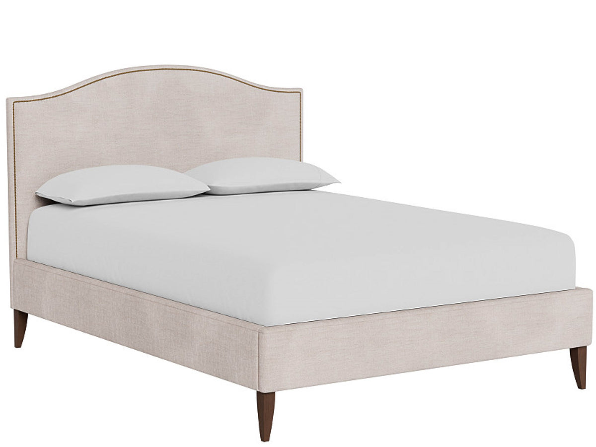An upholstered bed frame with a curved headboard and matching footboard, shown with a white mattress and two white pillows on a plain white background.
