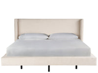 Beige upholstered bed with white bedding on a white background