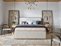 Modern bedroom with a bed, side tables, and decorative elements.