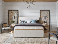 Modern bedroom with a bed, side tables, and decorative elements.