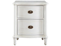 White nightstand with two drawers and brass handles on a white background