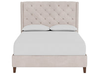Beige upholstered bed with tufted headboard on a white background