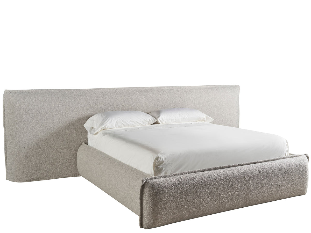 Beige upholstered bed with white bedding on a white background