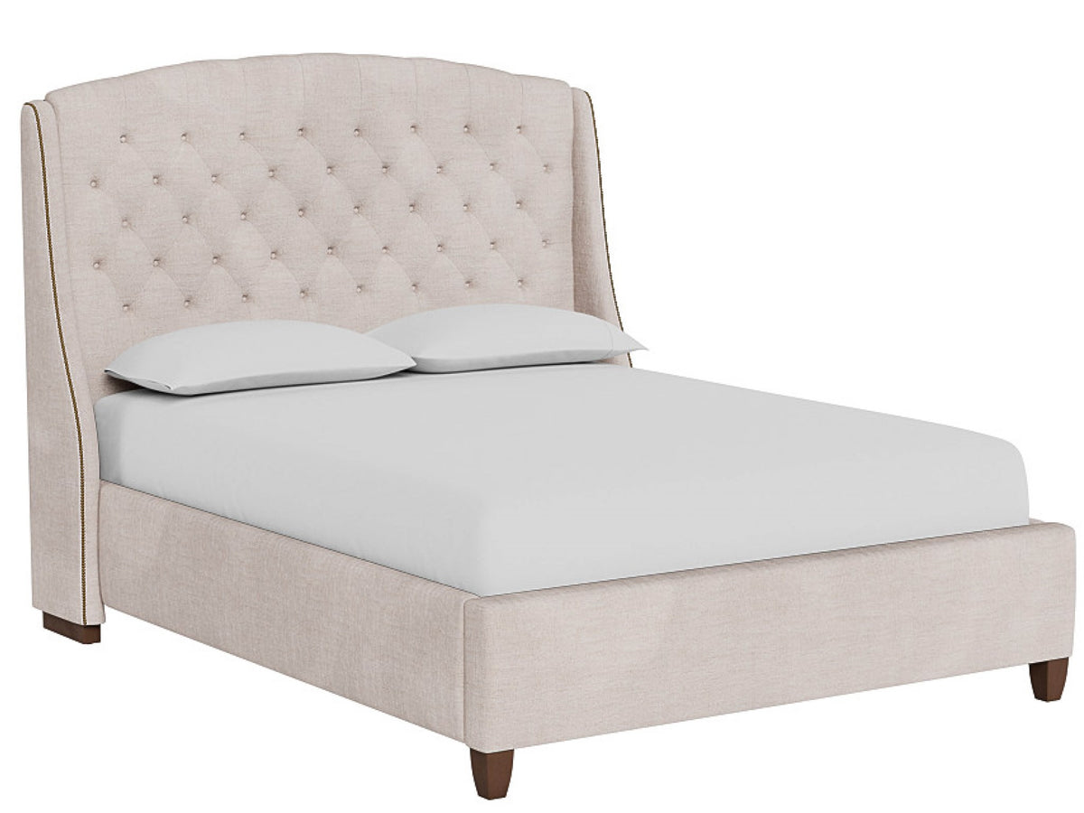 Beige upholstered bed with white bedding on a white background