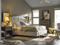 Neatly arranged bedroom with a large bed, side tables, and decor.