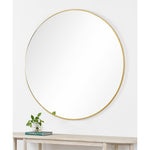 A mirror with brass frame on a white background