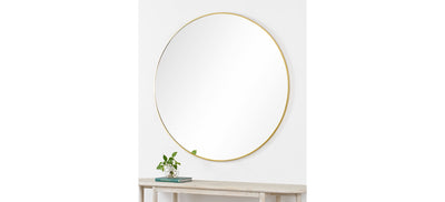 A mirror with brass frame on a white background