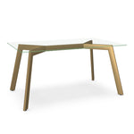 A clear glass top dining table with a brass accent base.