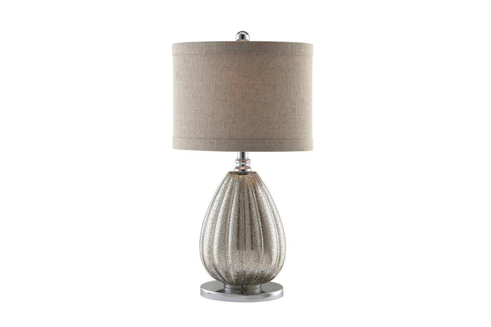 Table lamp with ribbed glass base and beige fabric shade on a white background