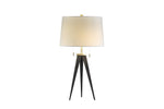 A modern table lamp with a white fabric shade, gold-colored metal base, and black adjustable legs.