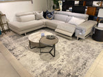 A power loom rug with a light grey color and a textured design.