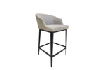 A counter stool with a gray fabric seat and slim black matte finish steel legs, featuring diamond quilted hand stitching.