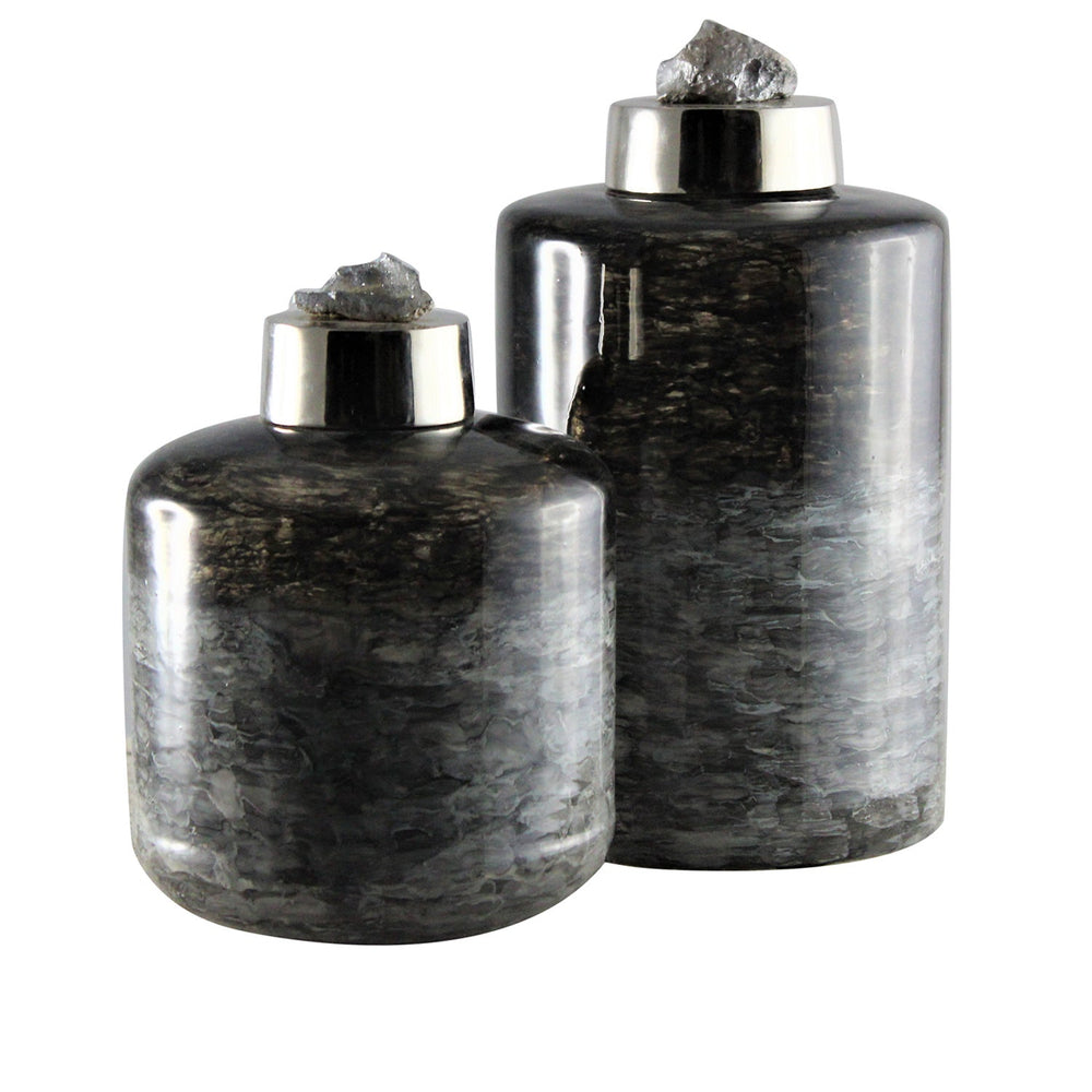 A pair of black glass decorative container with a white background