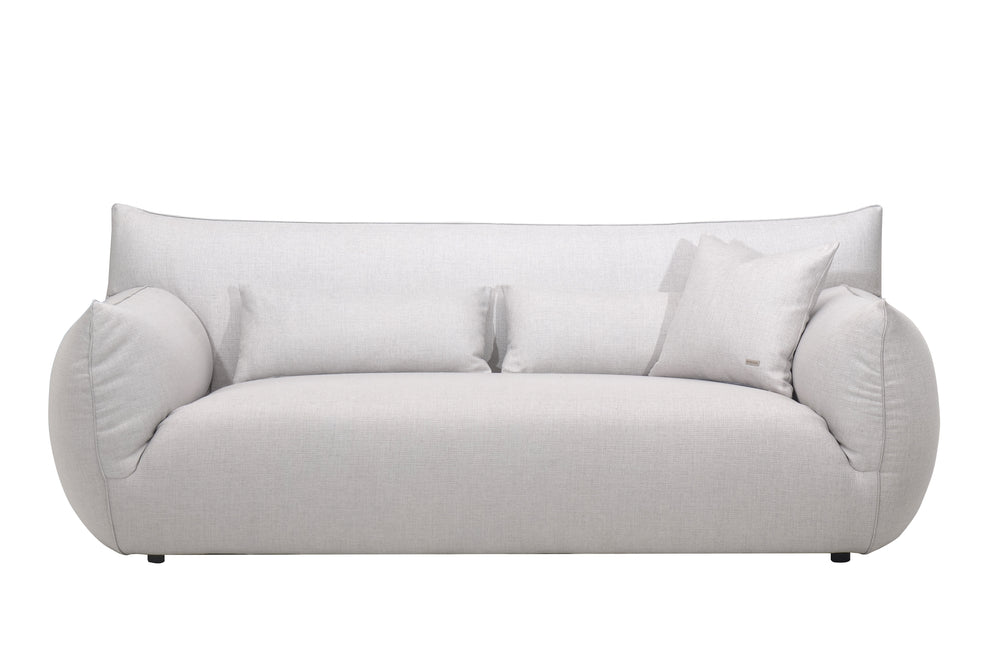 A plush Claudi sofa in a gray fabric, featuring a seamless cushion attached to the back and a sleek, modern design.