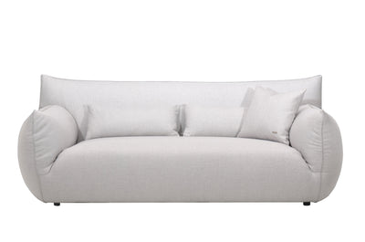 A plush Claudi sofa in a gray fabric, featuring a seamless cushion attached to the back and a sleek, modern design.