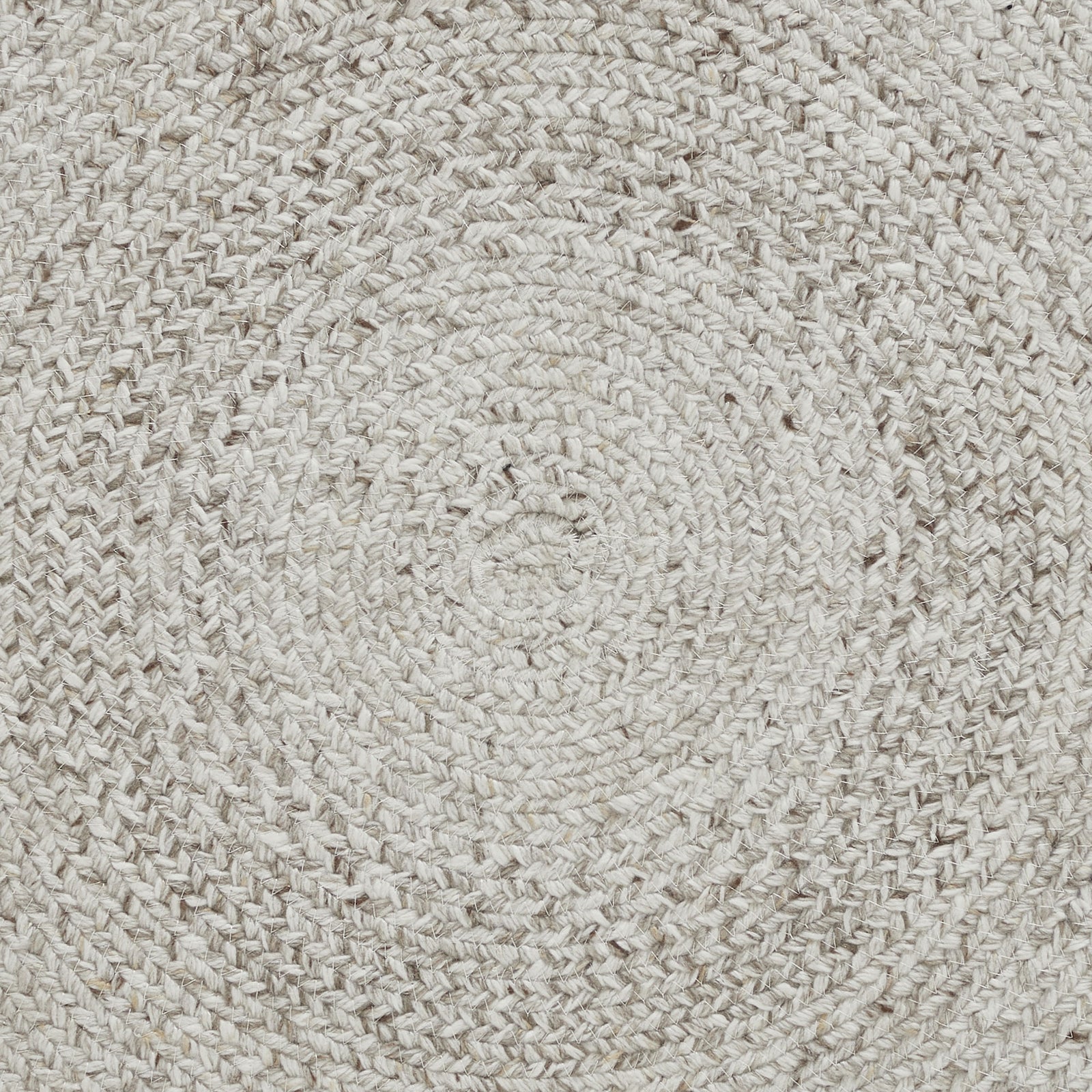 A round, beige area rug with a swirling geometric design