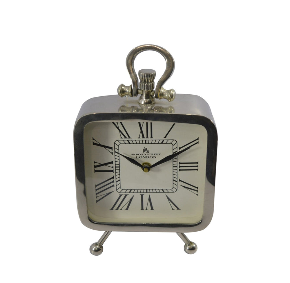 A silver square-shaped chrome clock with Roman numerals and a decorative handle on top.
