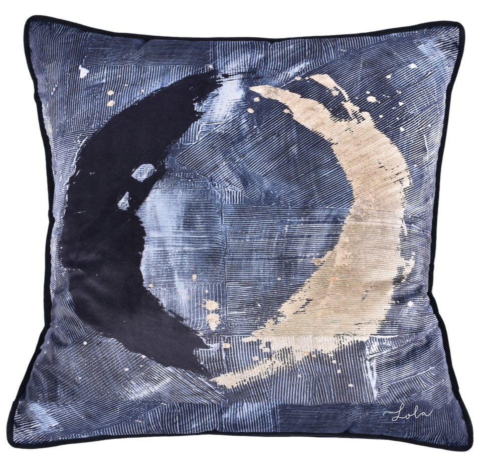 A decorative accent pillow with a dark color and abstract gold moon pattern.