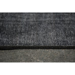 A dark navy area rug with a textured weave pattern, designed for use in a bedroom or hallway.