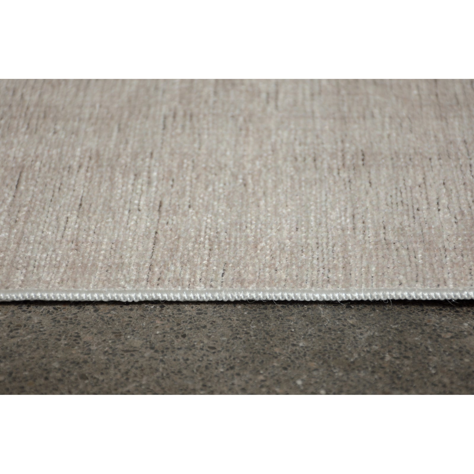 A light beige, solid pattern area rug.