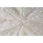 Round accent pillow with a white shearling exterior, solid white color, with a round shape