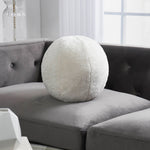 Round accent pillow with a white shearling exterior, solid white color, with a round shape