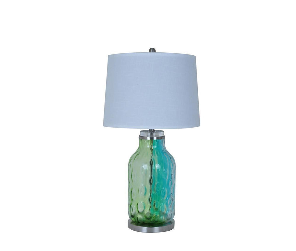 A green and blue mixed glass accent lamp on a white background