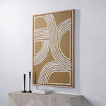 A canvas painting with abstract geometric lines in white and gold colors, framed in a white oak frame.